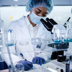 A female medical researcher writing down results